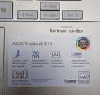 Close-up of a laptop label on an ASUS Vivobook S14 with Harman Kardon branding.