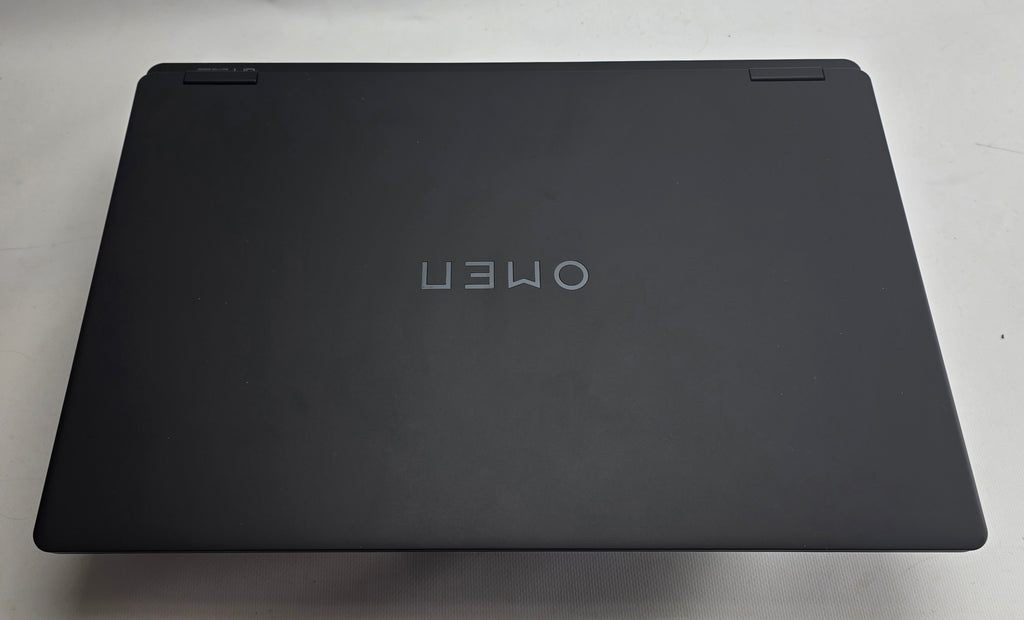 Black laptop with 'OMEN' branding on a light gray background