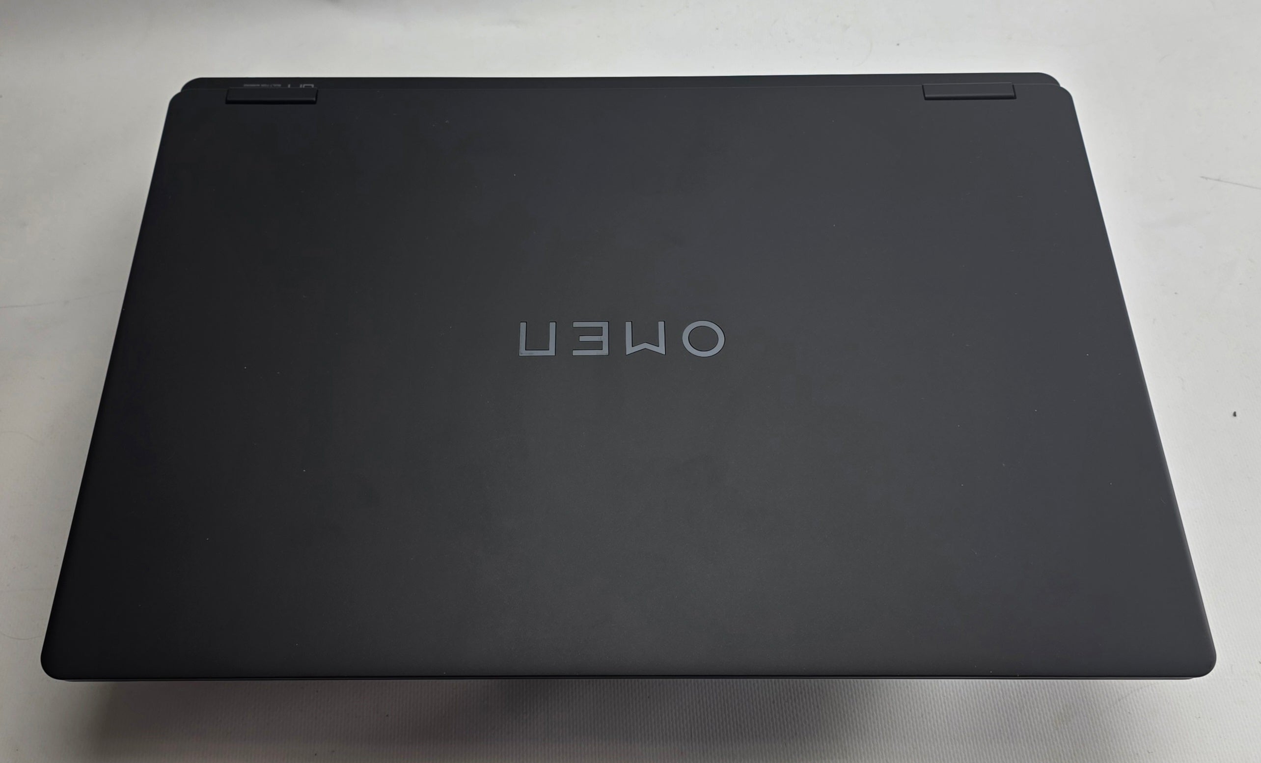 Black laptop with 'OMEN' branding on a light gray background