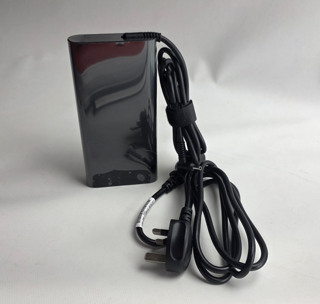 Black electronic device with a power cord on a white background