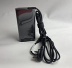 Black electronic device with a power cord on a white background