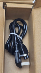 Black power cord with plug on a cardboard surface
