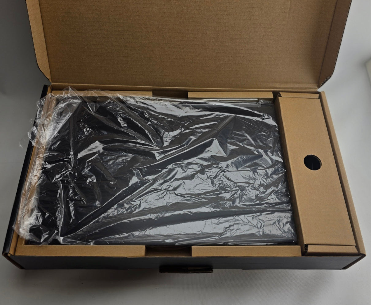 Open cardboard box with crumpled black plastic inside on a gray background