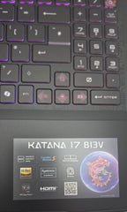 Close-up of a laptop keyboard with 'KATANA 17 B13V' branding on the screen.