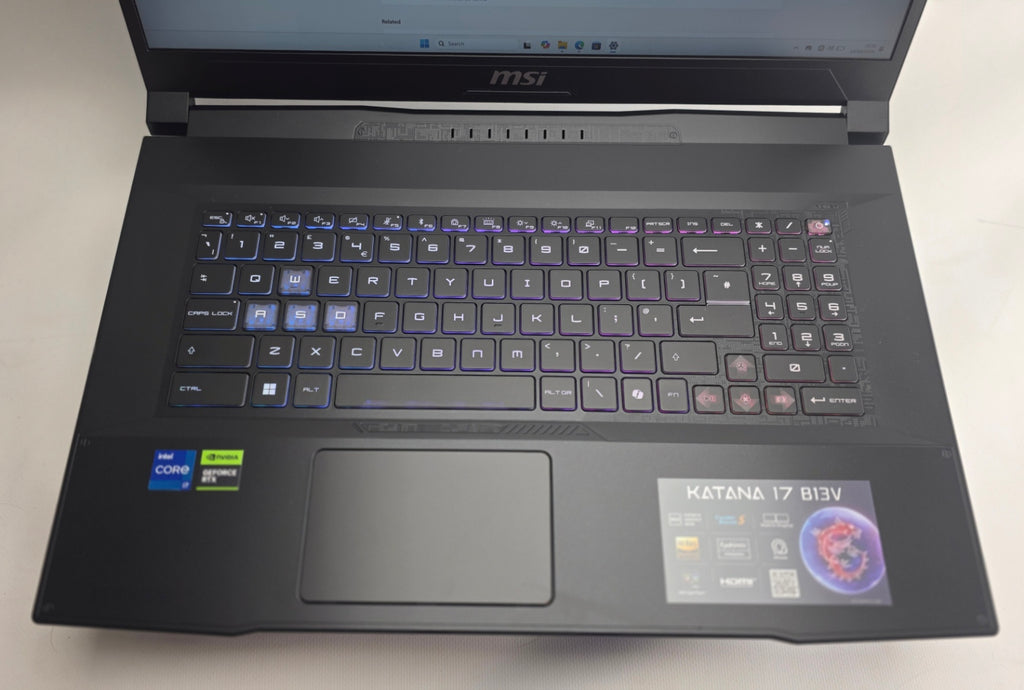 Black MSI laptop on a white surface